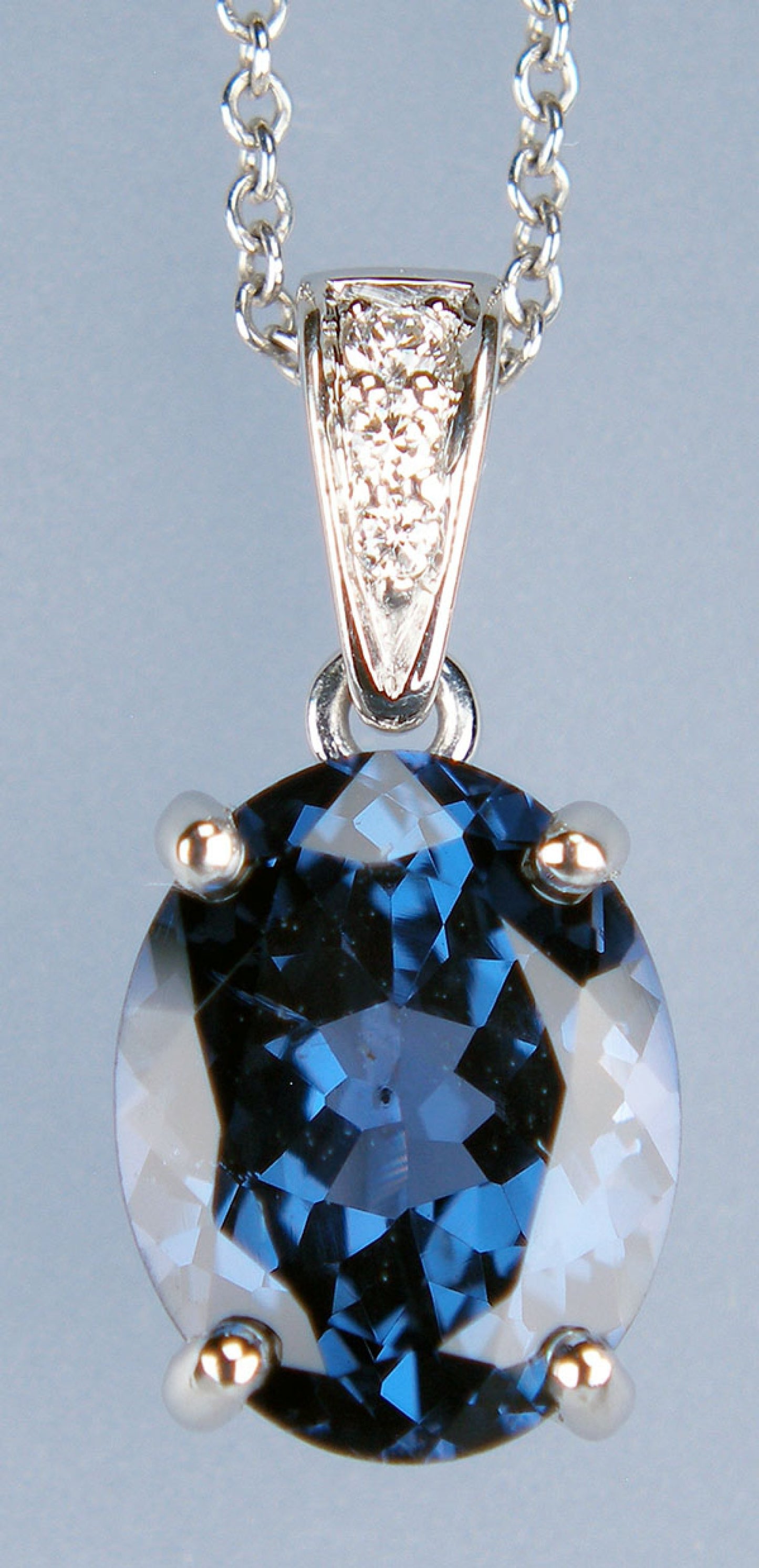 Colour change blue/purple oval spinel & diamond pendant in platinum
