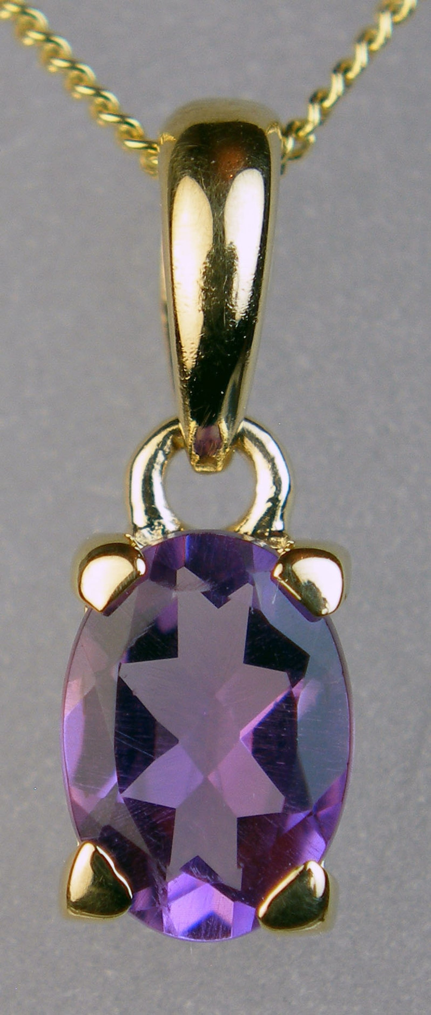 Amethyst oval pendant in 9ct yellow gold
