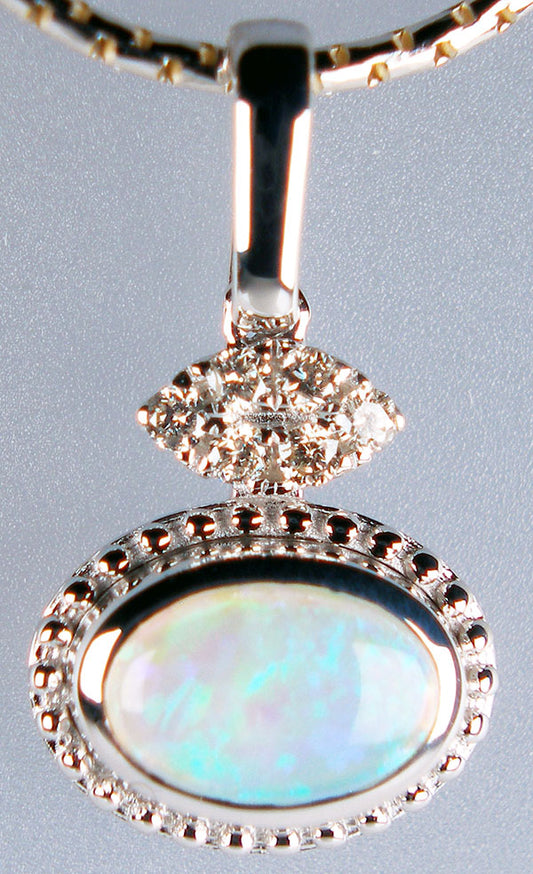 Oval opal & diamond pendant in 18ct white gold
