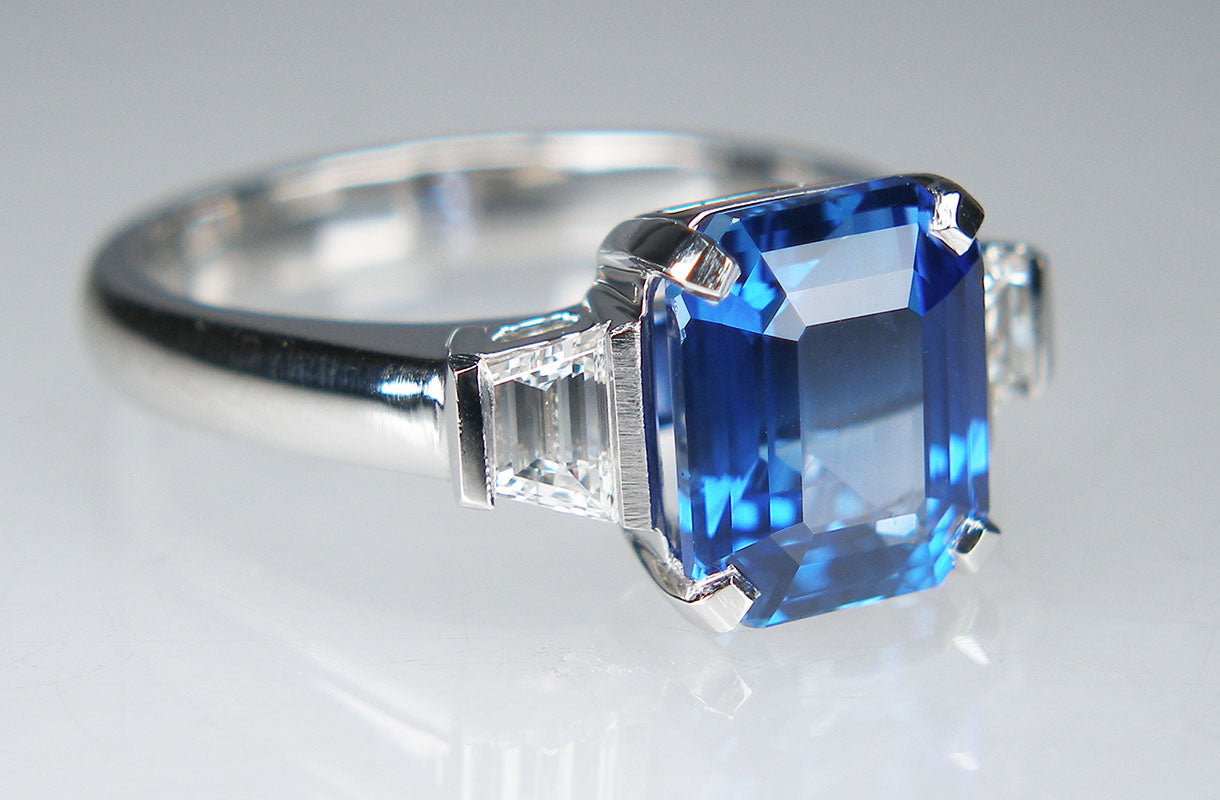 Asscher cut sapphire & tapered baguette cut diamond ring in platinum