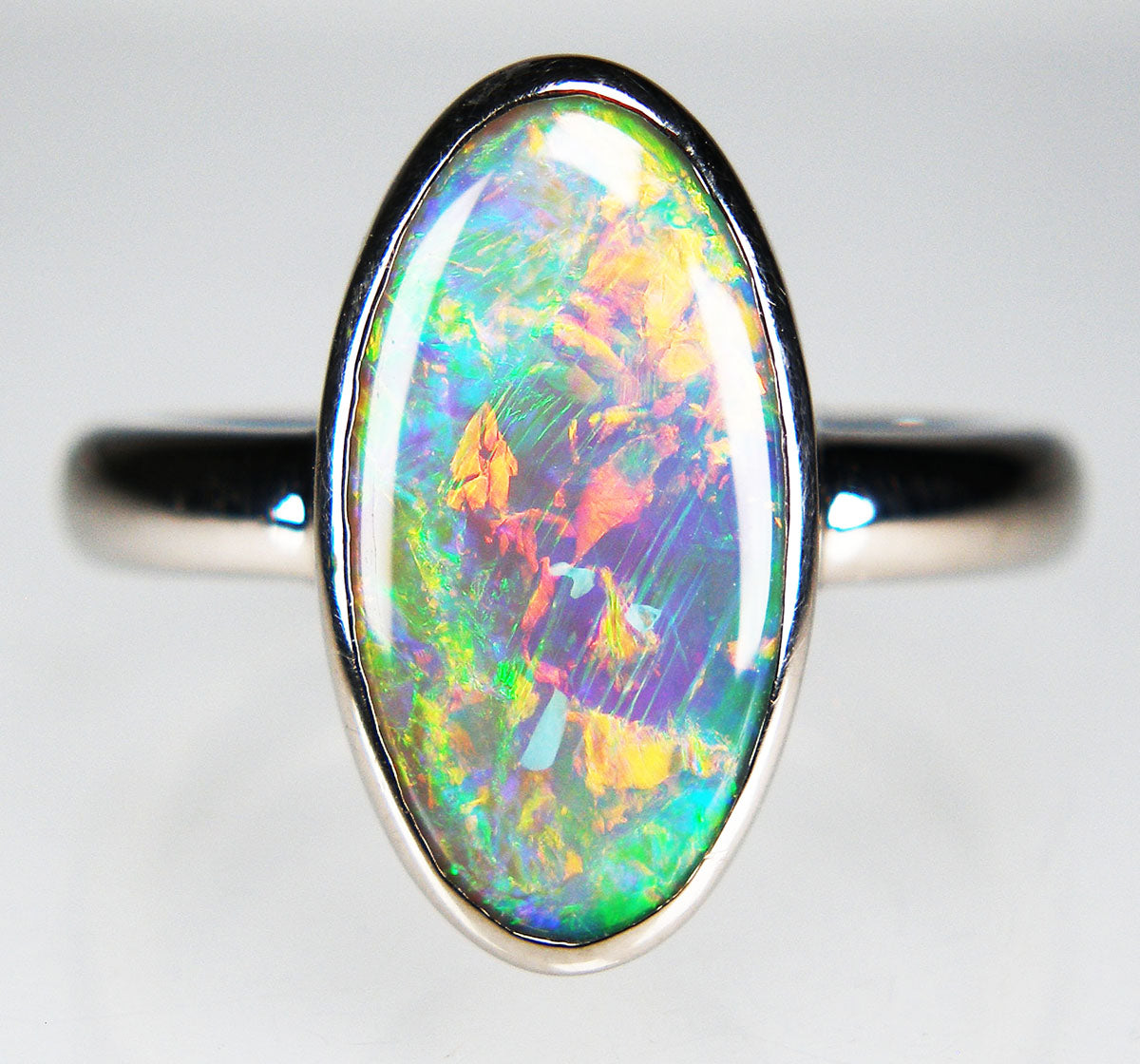 Dark crystal opal ring in 18ct white gold