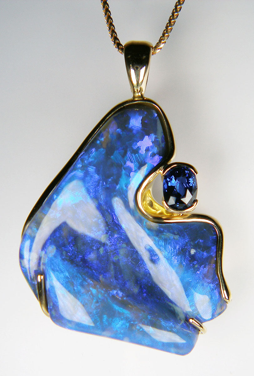 Black opal & sapphire pendant in 18ct yellow gold