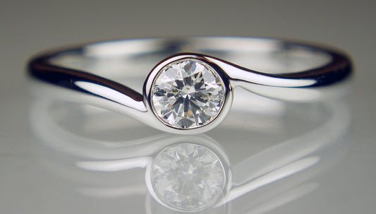 Diamond solitaire twist ring in 18ct white gold