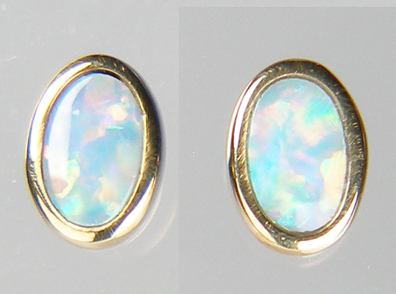 Tiny opal doublet earstuds in 9ct yellow gold
