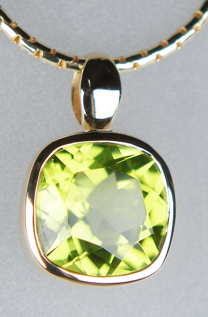 Cushion cut peridot pendant in 9ct yellow gold