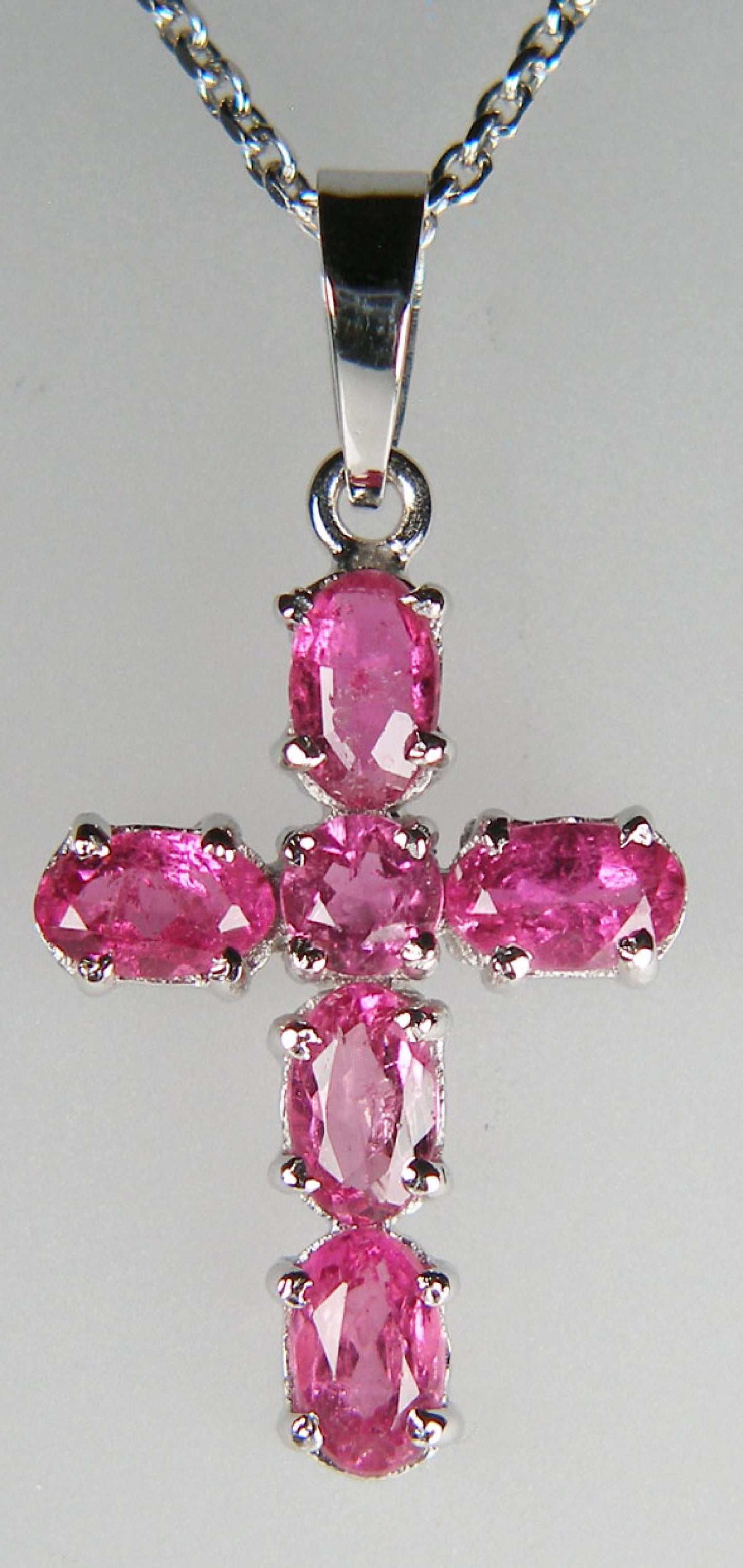 Bright pink tourmaline cross in 14ct white gold